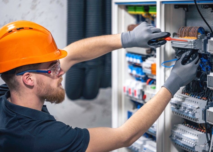 ProT Assist electrician working in a switchboard with fuses