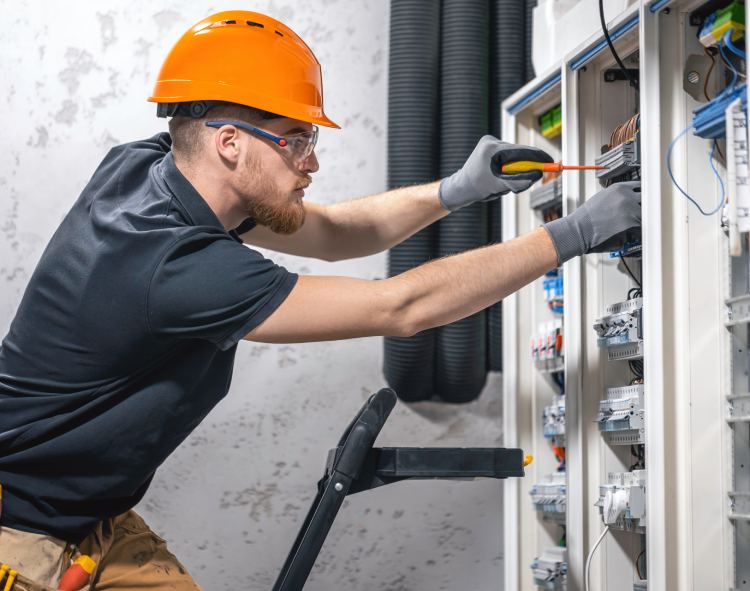 Our male electrician working in a high voltage switchboard with fuses